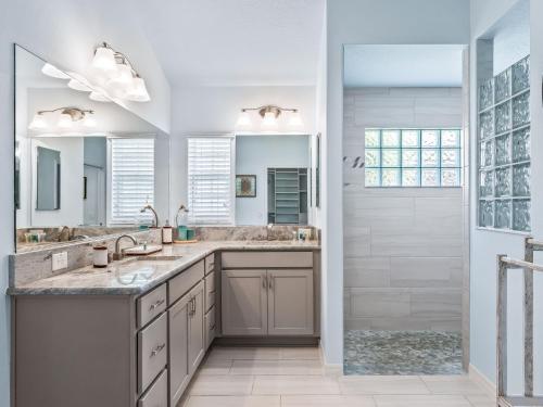 a bathroom with two sinks and a shower at 3215 Z6 VILLAGE OF FENNEY by REMAX Premier in The Villages