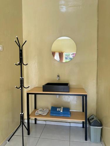 a bathroom with a sink and a mirror at Istana Bromo Resort in Bromo