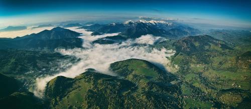 an aerial view of a mountain range with clouds at Wellness rezort Jánošíkov dvor in Zázrivá