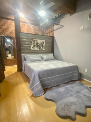 a bedroom with a large bed and a rug at Washington Loft in Saint Louis