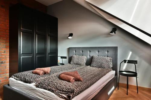 a bedroom with a large bed with pillows on it at Domillion New Modern Old town apt 16 ppl U2C1 in Vilnius
