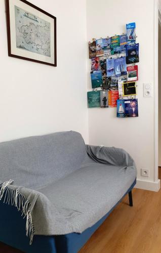 a bed in a room with a picture on the wall at Apartment in Passage on GR34 in Concarneau