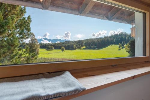 a large window with a view of a green field at Kesselmoos in Nova Ponente