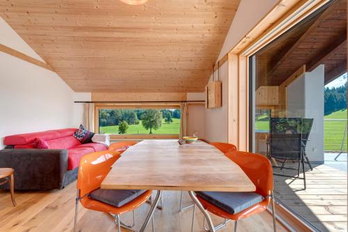 a living room with a wooden table and chairs at Kesselmoos in Nova Ponente