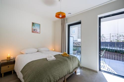 a bedroom with a bed and a large window at Madame Sardine in Ostend