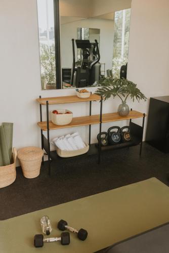 a room with a mirror and a table with weights at Casa Ofelia in Mexico City