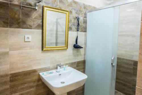 a bathroom with a sink and a mirror at Prestige Lodge Formula1 in Baku