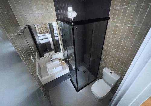 a bathroom with a shower with a toilet and a sink at Nord Class Rio 83 in João Pessoa
