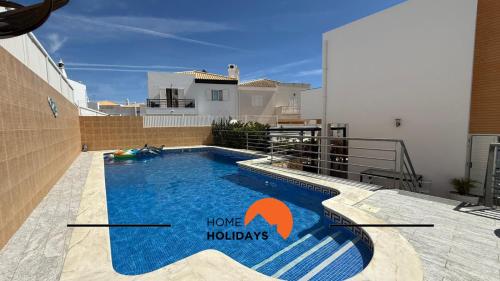 a swimming pool with a house holidays sign on it at #343 Villa with Pool & Jacuzzi by Home Holidays in Vale de Pedras