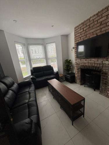a living room with a couch and a fireplace at City Centre Chic in Bangor