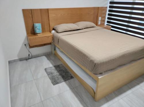 a bed in a bedroom with a wooden headboard at Marina Cerritos Mazatlan in La Florida