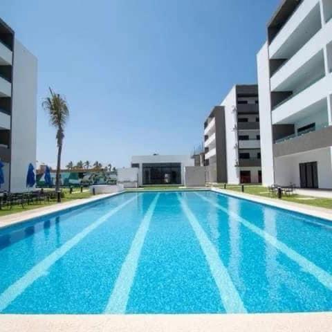 an empty swimming pool in front of a building at Marina Cerritos Mazatlan in La Florida