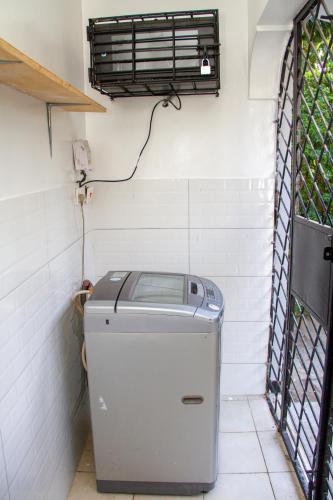 a small refrigerator in a room with a heater at Subree Luxury Villas- Nyali in Mombasa