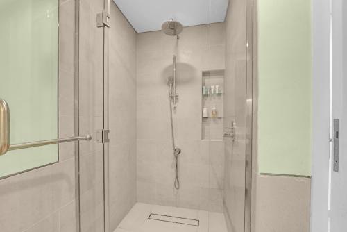a bathroom with a shower with a glass door at Stylish 1 Bedroom Apartment Near Burj Al Arab (Madinat Jumeirah) in Dubai