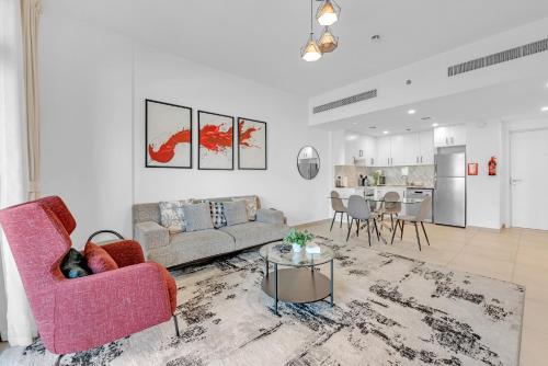 a living room with a couch and a table at Stylish 1 Bedroom Apartment Near Burj Al Arab (Madinat Jumeirah) in Dubai