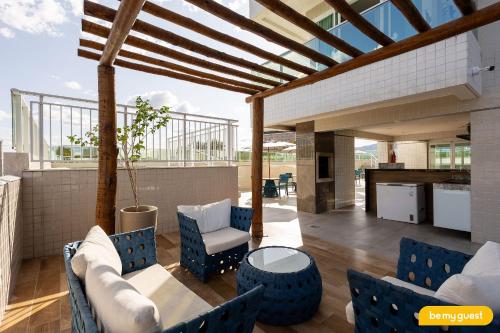a patio with blue chairs and a table at Design 1 - Sobral in Sobral