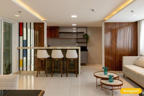 a living room with a bar with stools at Design 1 - Sobral in Sobral
