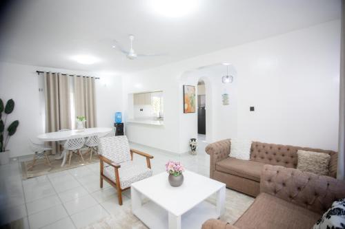 a living room with a couch and a table at Subree Luxury Villas- Nyali in Mombasa
