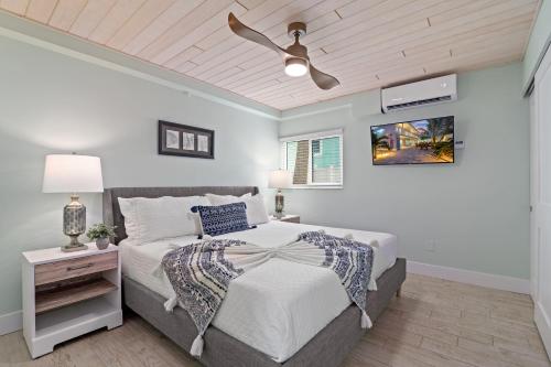 a bedroom with a bed and a ceiling fan at Sea Escape - Pet Friendly, Located in Siesta Key Village, Steps to Siesta Key Beach! in Bailey Hall