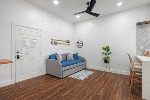 a living room with a blue couch and a ceiling fan at 30a Villages Of South Walton B190 - Free Bicycles in Seacrest