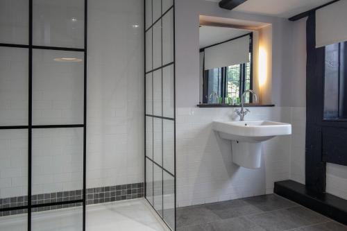 a bathroom with a sink and a mirror at The Olde Bell, BW Signature Collection in Marlow