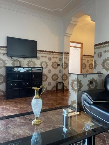 a living room with a vase on a glass table at Oasis Privado Castillejos in Riffiene