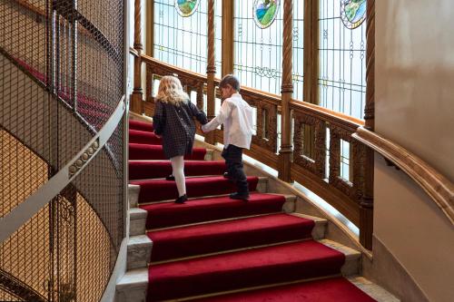 a boy and a girl walking down the stairs at Hotel Diplomat Stockholm in Stockholm