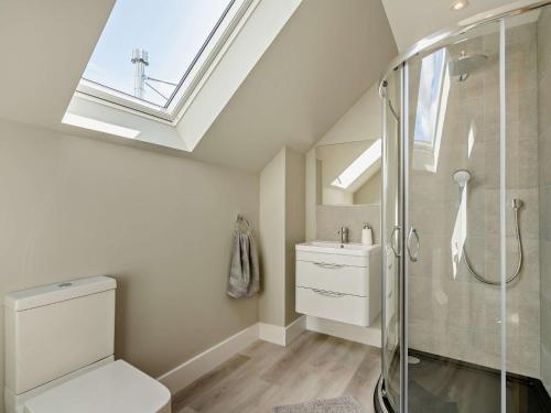 a bathroom with a shower and a toilet and a skylight at 2 Bed in Auchterarder 94546 in Auchterarder