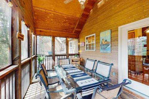a dining room with a table and chairs on a porch at Rest Haven in Branson West