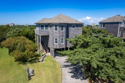 an aerial view of a large house with trees at 8455 - Mad Hatteras in Avon