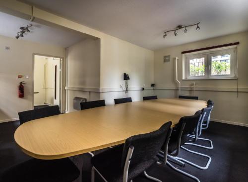 a conference room with a large wooden table and chairs at LSE Bankside House in London
