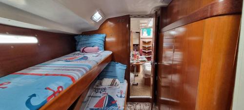 a small room with a bed and a closet at Sailing Edisa Rhodes Adventures in Rhodes Town