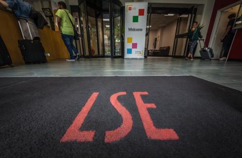 a red sign on the floor of a building with a store at LSE Bankside House in London