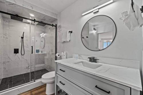 a white bathroom with a sink and a shower at Summit 803 - Luxury Beach Resort Condo 1-6 People in Panama City Beach