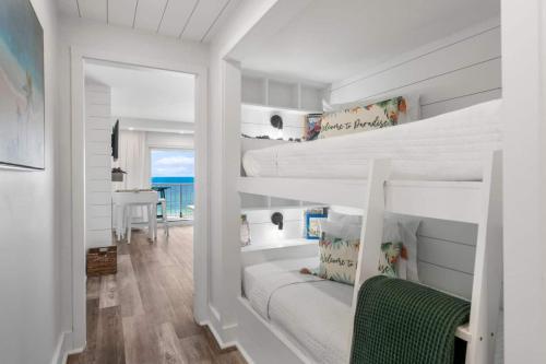 a bedroom with two bunk beds and a desk at Summit 808 - Luxury Beach Resort Condo 1-6 People in Panama City Beach