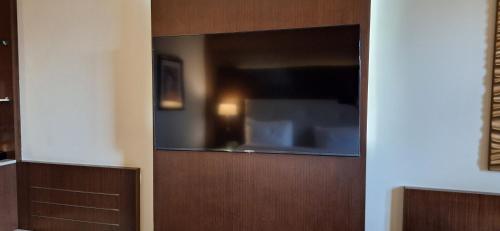 a wooden cabinet with a television in a room at Radisson Blu Hotel, Addis Ababa in Addis Ababa