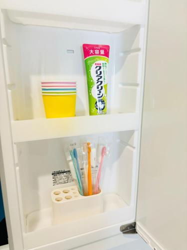a refrigerator door is open with school supplies at ZZOKIAI 橙霞 30-seconds walk to the seaside!4LDK maximun 10 people! in Itoman