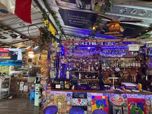 a bar with a lot of liquor bottles at Tambo Quinde in Tandayapa