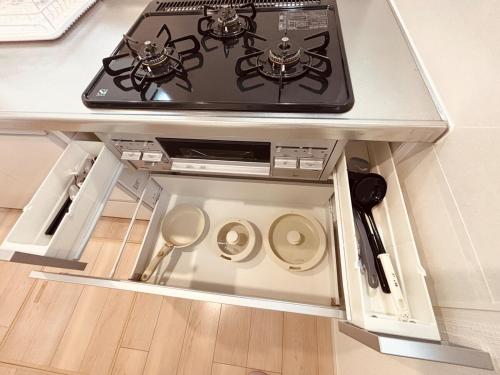 a stove top oven sitting on top of a table at ZZOKIAI 橙霞 30-seconds walk to the seaside!4LDK maximun 10 people! in Itoman
