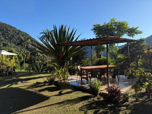 a wooden deck with a table and chairs at Tambo Quinde in Tandayapa