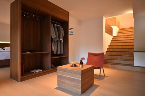 a bedroom with a bed and a room with a staircase at 至也 黄果树 in Xinggong