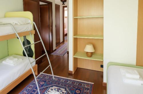 a room with two bunk beds and a hallway at Locazione turistica Ginestre Mare 