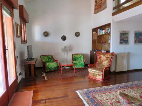 a living room with two chairs and a table at Locazione turistica Ginestre Mare 