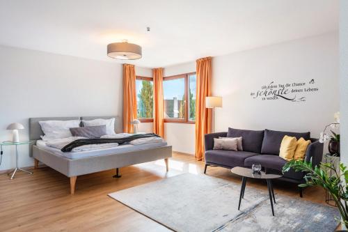 un salon avec un lit et un canapé dans l'établissement Die Ferienwohnung, à Bad Bellingen