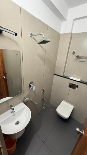 a bathroom with a sink and a toilet at Grand Sea Way in Chennai
