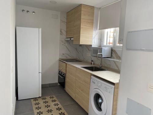 a small kitchen with a washing machine in it at CasaElbarranko in Arcos de la Frontera