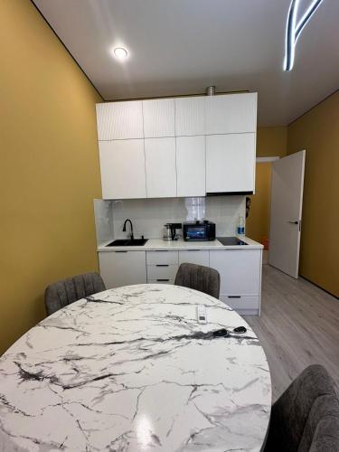 a kitchen with a large marble table and chairs at New Apartment in the City Center & Restaurants and Cafe & Famous sightseeings in Almaty