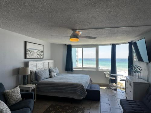 a bedroom with a bed and a view of the ocean at Beach Front Ocean View Condo - Top Of The Gulf 615 in Panama City Beach