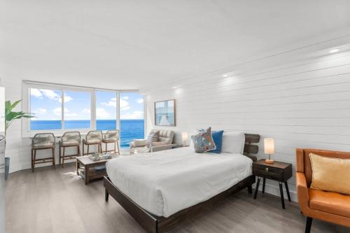 a bedroom with a bed and a view of the ocean at Renovated Beach Front Ocean View Condo Tog 723 in Panama City Beach