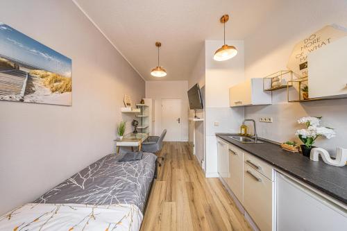 a small apartment with a bed and a kitchen at Moderne Single Apartments Hauptbahnhof in Halle an der Saale